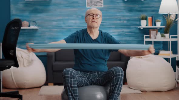 Pensioner on Toning Ball Training with Resistance Band