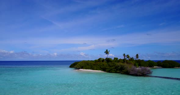 Wide angle flying abstract view of a white sand paradise beach and blue water background