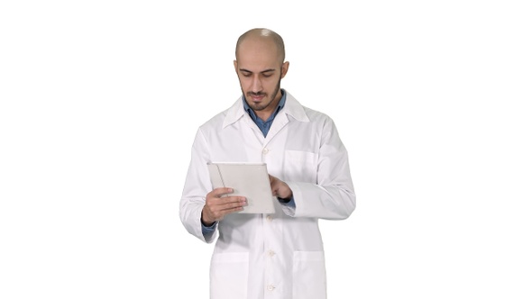 Mature male doctor holding digital tablet using it and