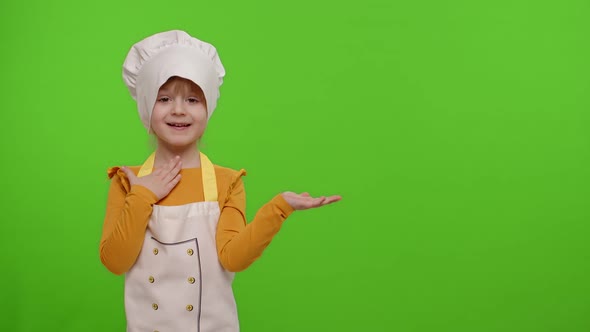 Child Girl Dressed Like Chef Cook Pointing at Right on Blank Space Place for your Advertisement Logo