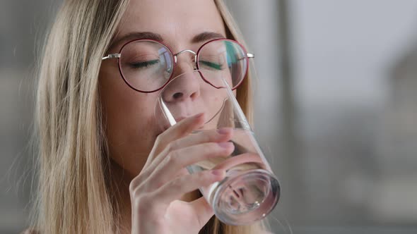 Close Up Thirsty Caucasian Woman in Glasses Drinking Clean Fresh Transparent Pure Filtered Mineral