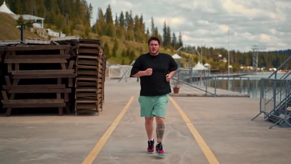 Young fat man is jogging training loses weight