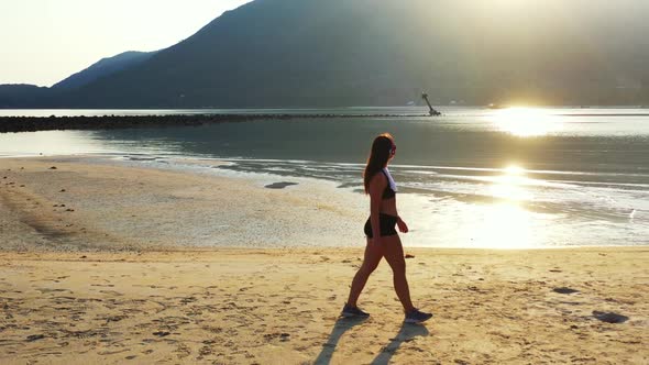 Women look beautiful on exotic coast beach adventure by blue green sea with white sand background of