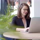 Happy Young Businesswoman Using Laptop Computer in a Cafe - VideoHive Item for Sale