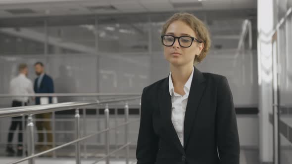 Businesswoman Walking Along the Office Corridor