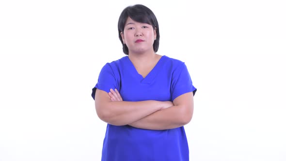 Happy Overweight Asian Businesswoman Smiling with Arms Crossed