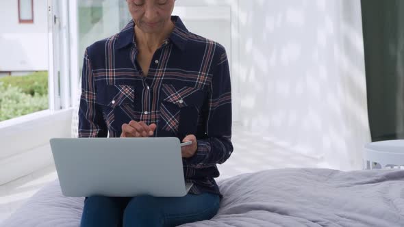 Mature woman using technology at home