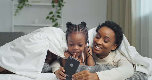 Funny Afro American Happy Ethnic Black Family Lying on Sofa Covered with Blanket Little African