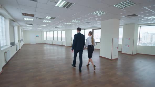 Business Meeting Couple of Top Managers Goes to a Meeting the Interior of a White Office Space with