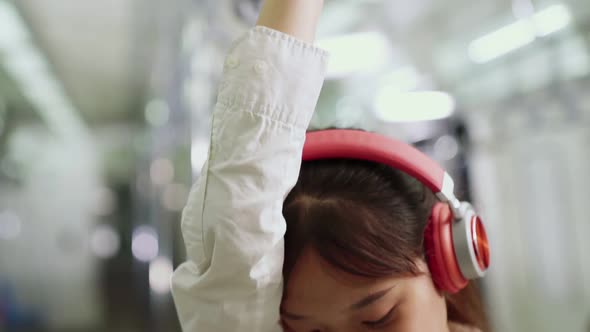 Young Woman Using Mobile Phone on Public Train