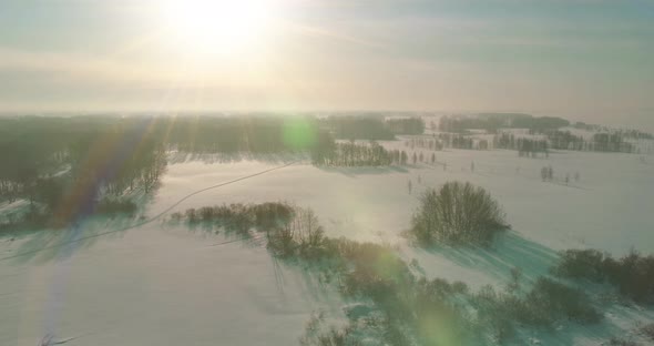 Aerial View of Cold Winter Landscape Arctic Field Trees Covered with Frost Snow Ice River and Sun