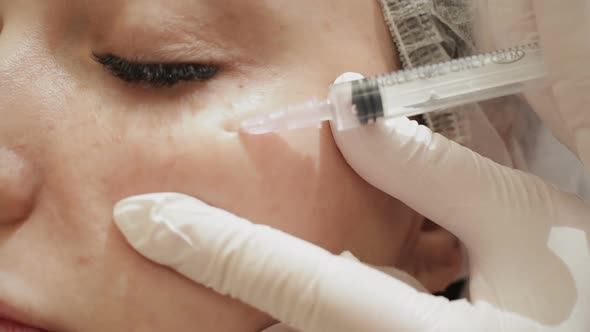 Closeup of Beautiful Woman Receiving Facial Beauty Injections