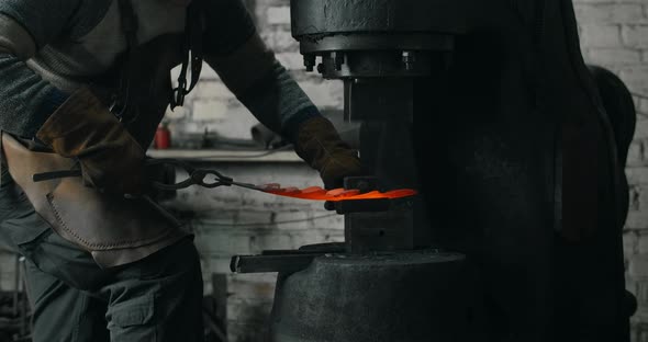Blacksmith Makes a Decorative Redhot Forged Metal Product with Hydraulic Hammer Blacksmith's