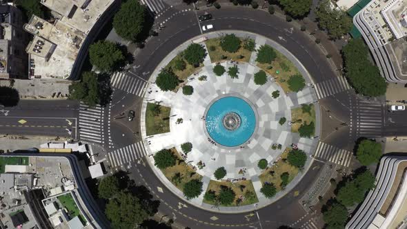 Aerial top down rotation of Dizengoff Square in Tel Aviv, Israel showing street traffic, green areas