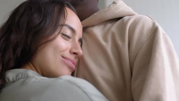 Close Up Of Loving Young Couple At Home Hugging In Kitchen Together