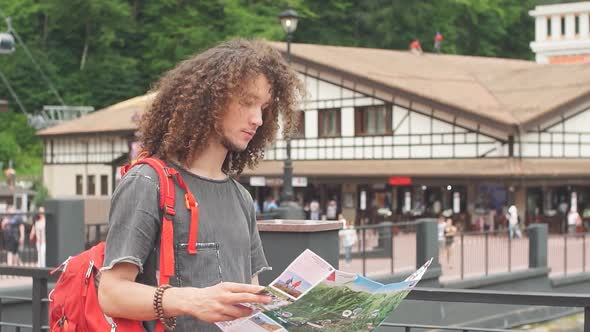 Tourist with Route Maps Looking for a Way in City. Search Landmarks