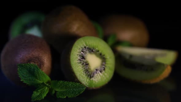 Fruits of Juicy Beautiful Kiwi Lie on a Table on a Black Background