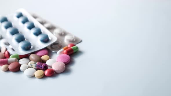 Close Up of Colorful Pills Spilling on White Background 