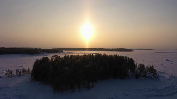 Frozen Kandalaksha Bay and Tree Islands on Winter Sunny Day