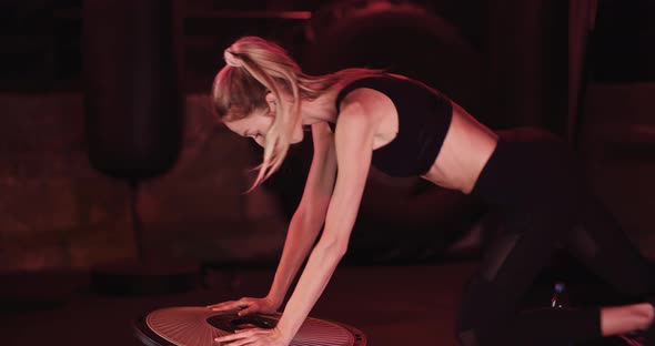 Slim Woman Exercising At Health Club
