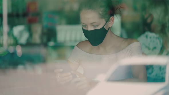 Woman in Protective Mask in Cafe