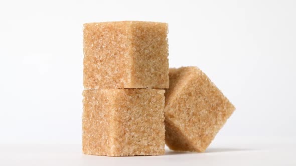 Cubes of Brown Sugar Rotating on White Background