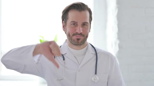 Portrait of Young Doctor Showing Thumbs Down Gesture
