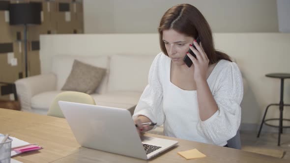 Focused Manager Talking on Mobile Phone