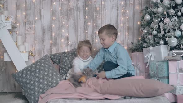 Junior Schoolboy and Toddler Girl Play Happily in Bedroom