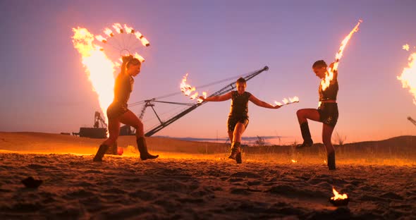 Professional Artists Show a Fire Show at a Summer Festival on the Sand in Slow Motion