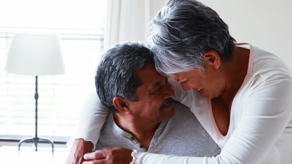 Senior couple embracing each other in bedroom 4k