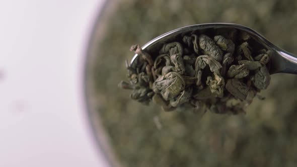 Dried coiled leaves of green Chinese tea powder closeup. 