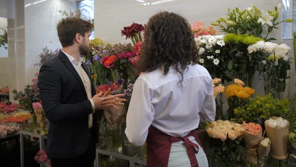 Florist Advising Client Flowers for Composition