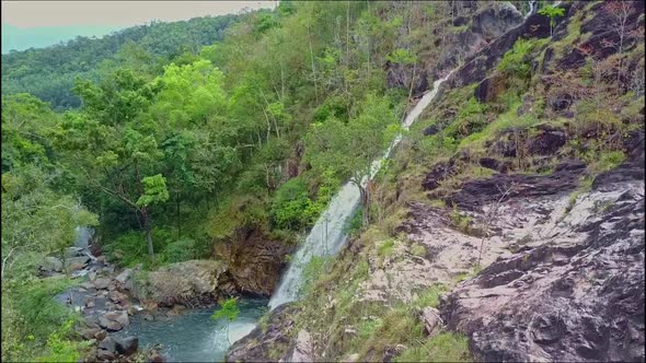 Aerial View Hilly Landscape with Waterfall Lake and Jungles