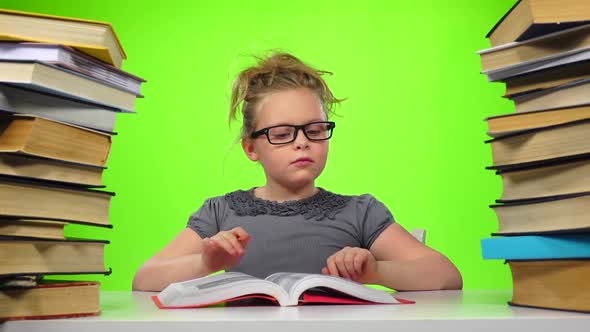 Girl Leafing Through the Pages of Books Carefully. Green Screen. Slow Motion