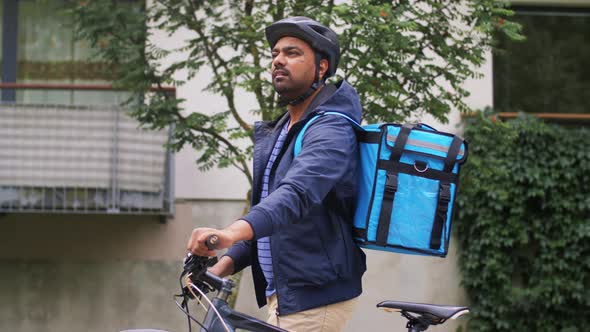 Indian Delivery Man with Bag and Bicycle in City