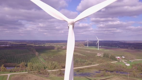 Aerial view of wind turbine creating green and renewable energy.  Camera view is descending in eleva