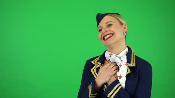 A Young Beautiful Stewardess Celebrates with a Smile - Green Screen Studio