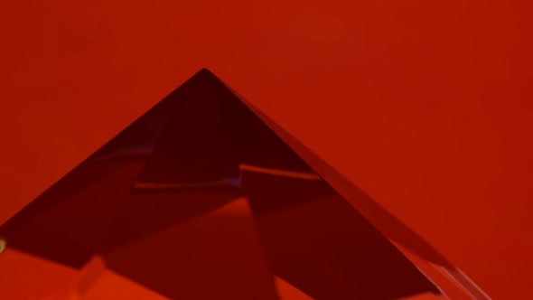 Pointed End of the Diamond Turns and Shimmers. Red Background