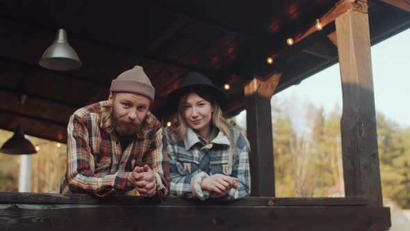 Portrait of Young Beautiful Couple on Wooden Terrace