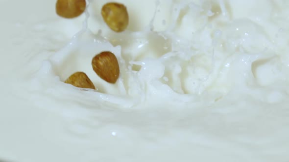 Shelled hazelnuts being dropped into milk, Ultra Slow Motion