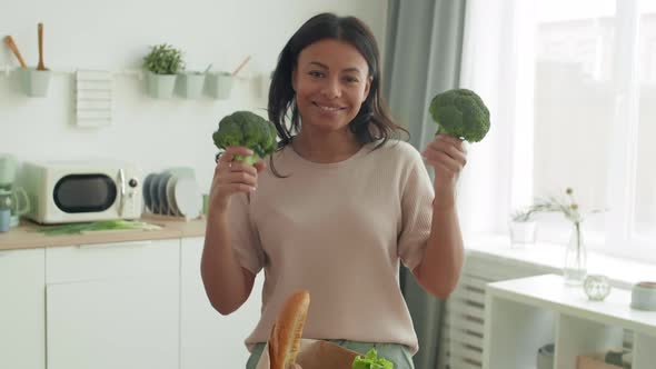 Woman Dancing with Broccoli in Her Hands