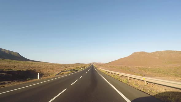 Driving in desert Fuerteventura on a summer day