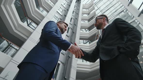 Low-Angle Shot of Businessman Shaking Hand to his Lawyer
