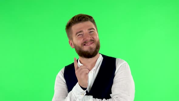 Guy Listens Carefully with a Smile and Then Waves His Finger. Green Screen