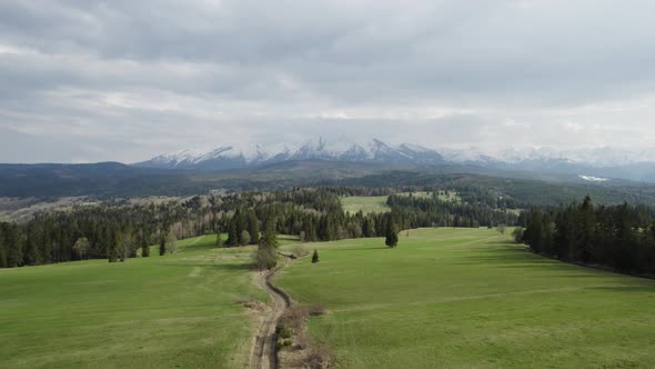 Drone flying forwards though Tatra Mountains in vast natural terrain