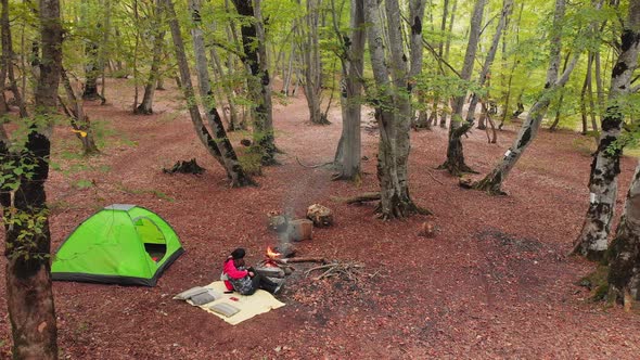 Caucasian Woman Hugs Boy In Camping Spot By Fire 