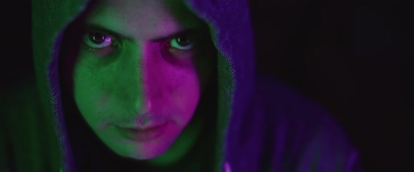 Close up of a young man with eyes wide open, wearing a hoodie