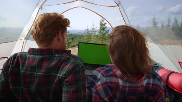 Back View Focused Man and Woman Watching Movie on Laptop with Green Screen