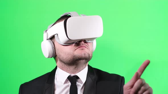 Business Worker Uses Virtual Reality Glasses on the Background of a Chromakey